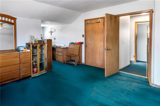 interior space featuring vaulted ceiling and carpet flooring