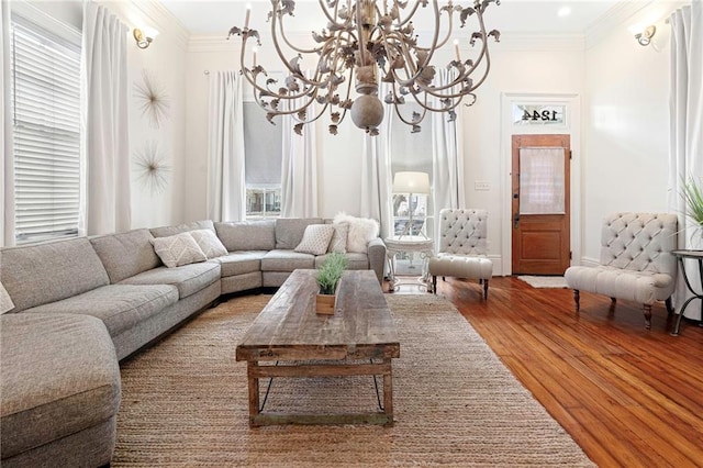 1244 Annunciation St, New Orleans, LA 70130 - living area with a notable chandelier, plenty of natural light, ornamental molding, and wood finished floors