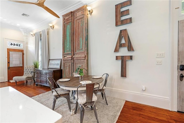 1244 Annunciation St, New Orleans, LA 70130 - dining room with baseboards, crown molding, visible vents, and wood finished floors