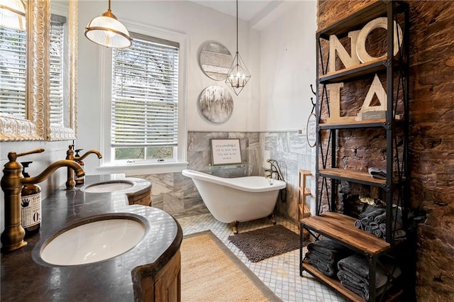 1244 Annunciation St, New Orleans, LA 70130 - full bath with a freestanding bath, a wainscoted wall, vanity, and tile walls
