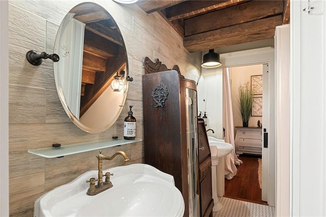 1244 Annunciation St, New Orleans, LA 70130 - bathroom featuring beam ceiling, tile walls, and a sink