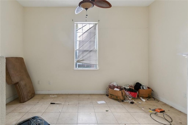 unfurnished dining area featuring plenty of natural light, a ceiling fan, and baseboards