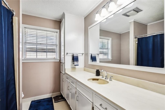 bathroom featuring visible vents, ornamental molding, a textured ceiling, and vanity