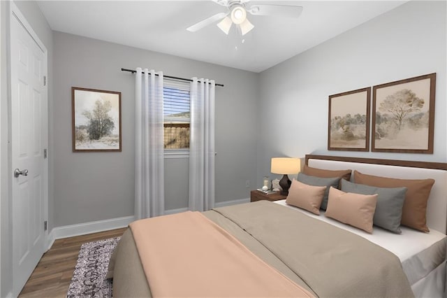 bedroom featuring ceiling fan, baseboards, and wood finished floors