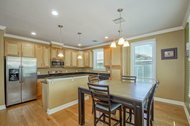 kitchen with stainless steel appliances, light wood-style flooring, light brown cabinets, and visible vents