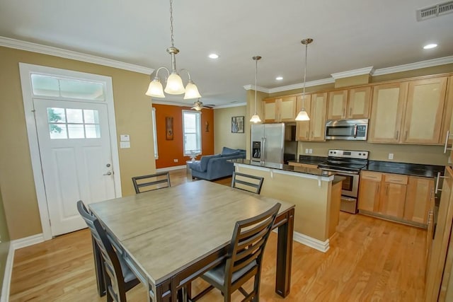 kitchen with light wood finished floors, visible vents, appliances with stainless steel finishes, ornamental molding, and light brown cabinets