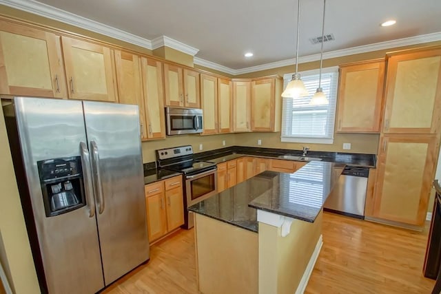 kitchen featuring light wood finished floors, light brown cabinetry, appliances with stainless steel finishes, ornamental molding, and a sink