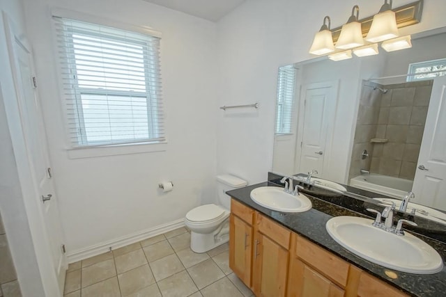 bathroom with double vanity, tile patterned flooring, a sink, and toilet