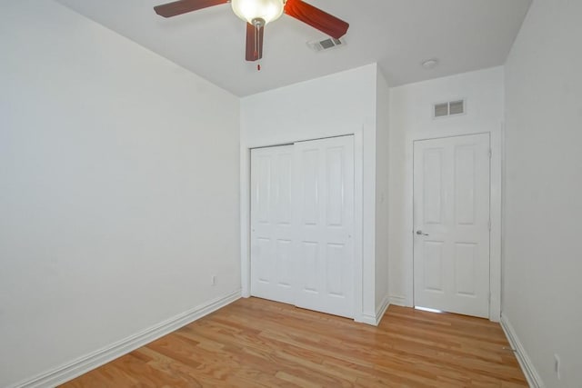 unfurnished bedroom featuring baseboards, visible vents, and light wood-style floors