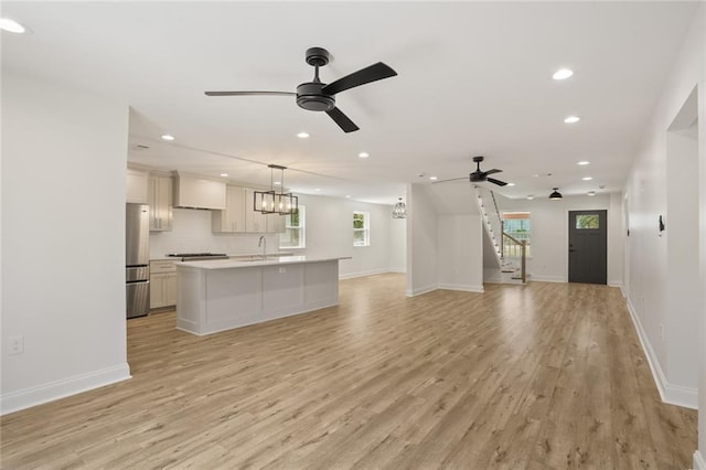 6043 Paris Ave, New Orleans, LA 70122 - unfurnished living room with recessed lighting, light wood-style flooring, ceiling fan, and baseboards