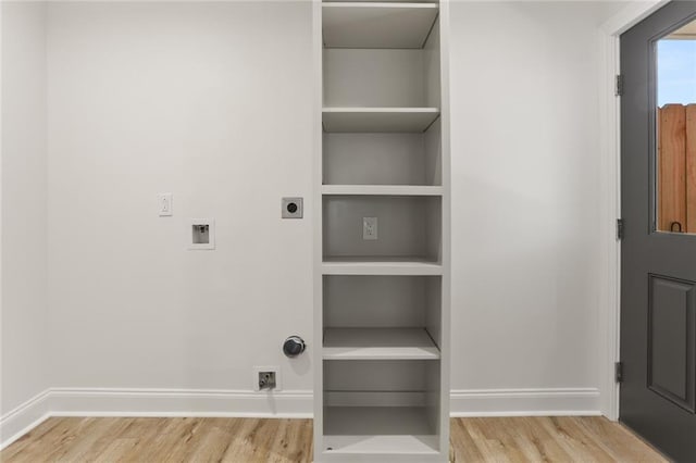 6043 Paris Ave, New Orleans, LA 70122 - laundry room featuring electric dryer hookup, wood finished floors, washer hookup, and built in shelves