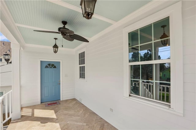 doorway to property featuring ceiling fan and a porch