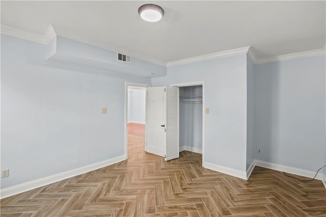 unfurnished bedroom featuring ornamental molding, a closet, visible vents, and baseboards