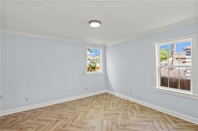 empty room featuring baseboards, a wealth of natural light, and ornamental molding