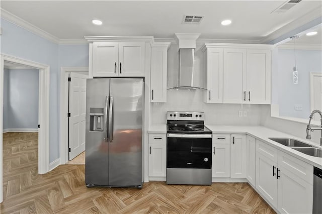 kitchen with crown molding, stainless steel appliances, visible vents, a sink, and wall chimney range hood