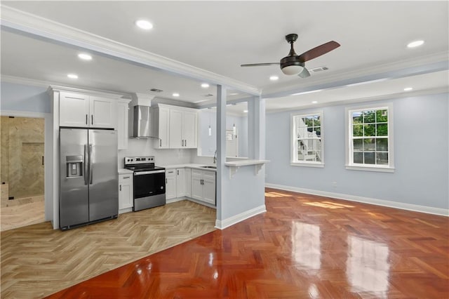 kitchen with wall chimney exhaust hood, appliances with stainless steel finishes, ornamental molding, a sink, and baseboards