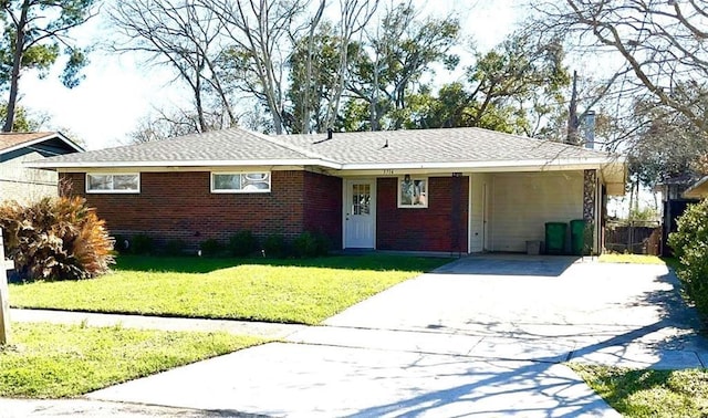 single story home with driveway, a front lawn, and brick siding