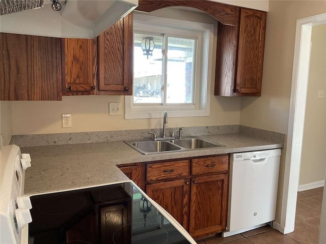 kitchen with light countertops, brown cabinetry, a sink, tile patterned flooring, and dishwasher