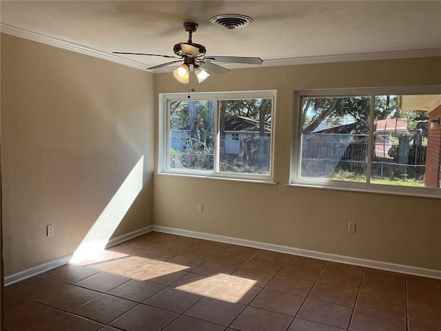 unfurnished room featuring baseboards, visible vents, and ornamental molding