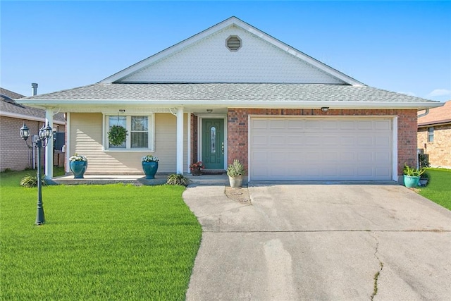 view of front of house featuring a garage, a front lawn, concrete driveway, and roof with shingles