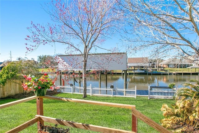 exterior space with a water view and fence