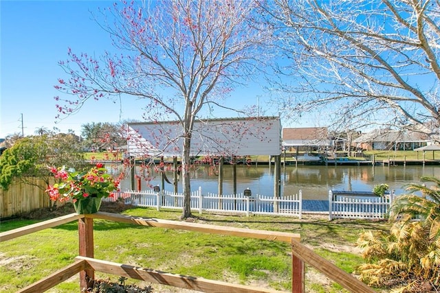 view of yard featuring a water view and fence