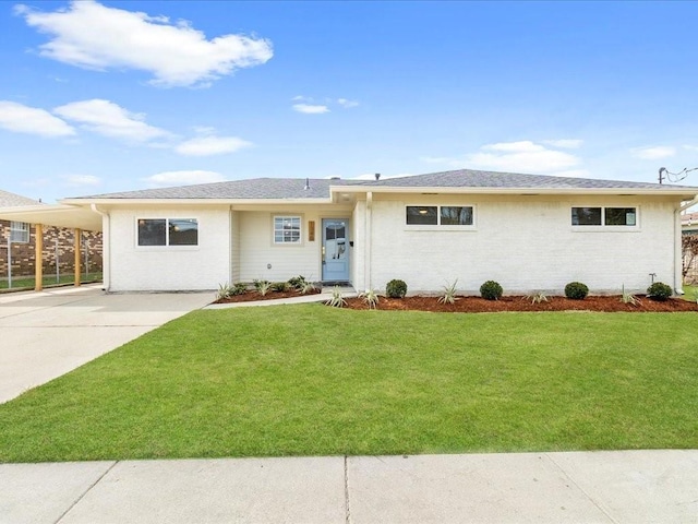 ranch-style house with driveway, a front lawn, and an attached carport