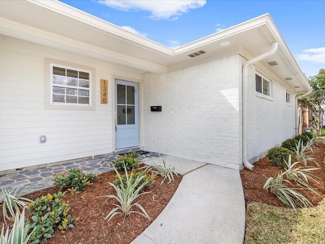 property entrance with brick siding