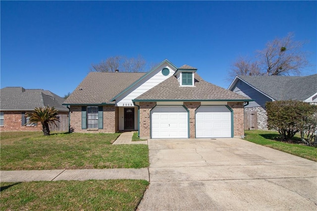 view of front of house featuring a garage, a front lawn, concrete driveway, and brick siding