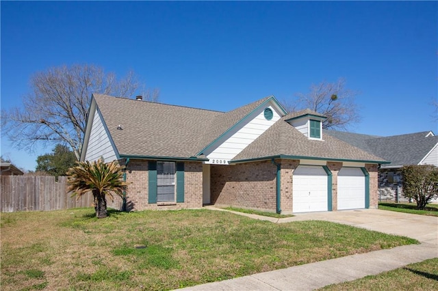 view of front of property with an attached garage, fence, concrete driveway, and a front yard