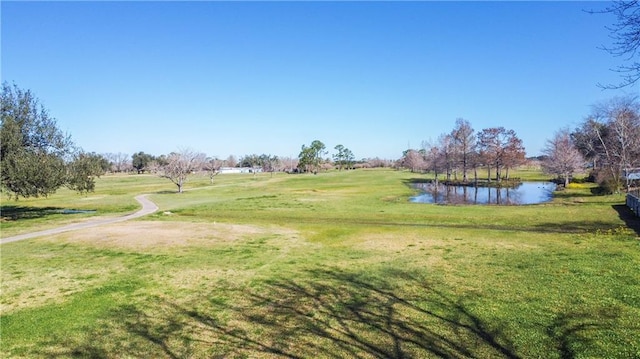 view of property's community with a yard and a water view