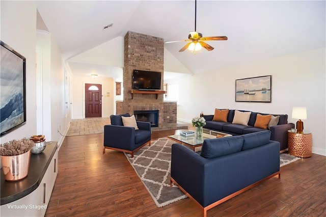 living area featuring ceiling fan, high vaulted ceiling, dark wood-style flooring, a fireplace, and visible vents