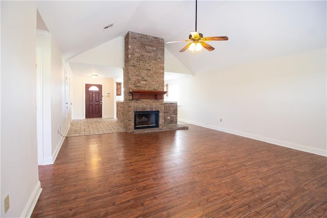 unfurnished living room featuring visible vents, a ceiling fan, dark wood-type flooring, a brick fireplace, and high vaulted ceiling