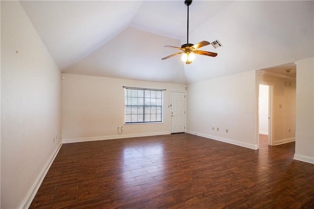 spare room featuring vaulted ceiling, dark wood-style flooring, ceiling fan, and baseboards