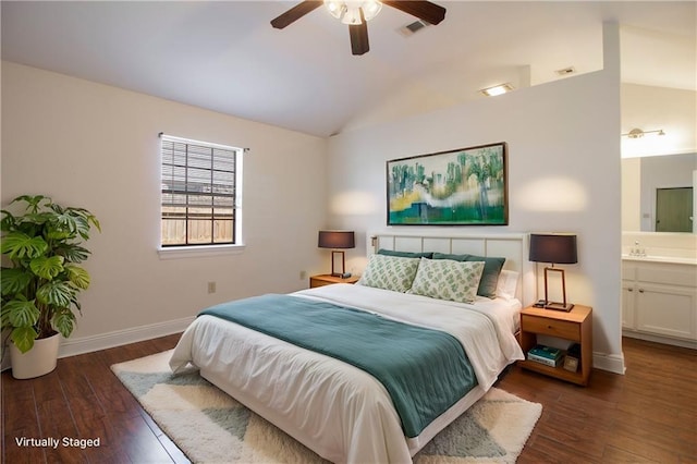 bedroom with lofted ceiling, ensuite bathroom, wood finished floors, visible vents, and baseboards