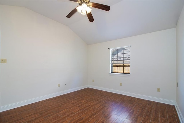 unfurnished room featuring dark wood-style flooring, vaulted ceiling, baseboards, and ceiling fan