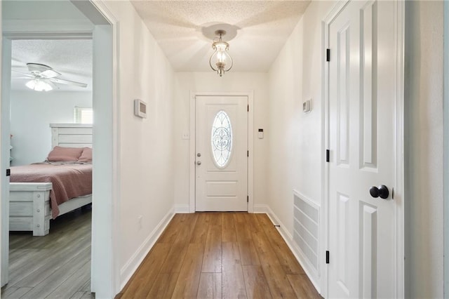 38 Moss Dr, La Place, LA 70068 - interior space with visible vents, ceiling fan, a textured ceiling, baseboards, and hardwood / wood-style flooring