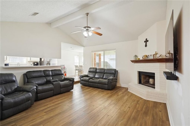 38 Moss Dr, La Place, LA 70068 - living area featuring beam ceiling, a fireplace, visible vents, hardwood / wood-style floors, and baseboards