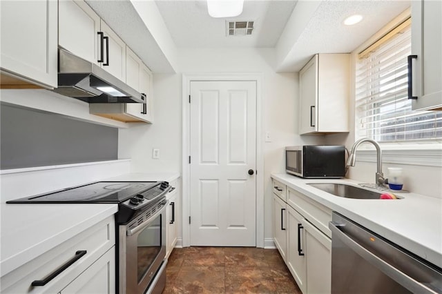 38 Moss Dr, La Place, LA 70068 - kitchen with stainless steel appliances, light countertops, visible vents, a sink, and under cabinet range hood
