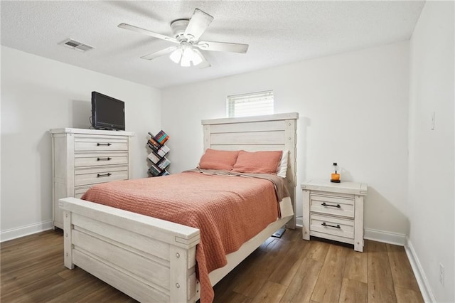 38 Moss Dr, La Place, LA 70068 - bedroom with a textured ceiling, wood finished floors, visible vents, and baseboards