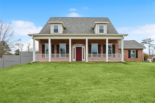 view of front of property with a porch, brick siding, fence, roof with shingles, and a front yard