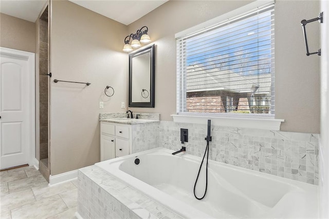 full bathroom featuring a garden tub and vanity