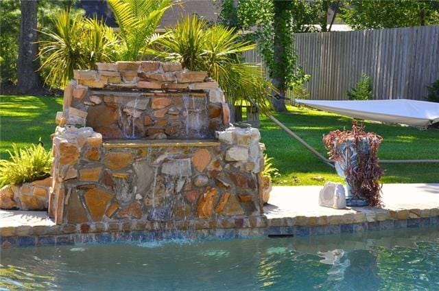 exterior space featuring a fireplace and fence