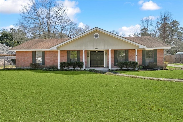 single story home with fence, a front lawn, and brick siding