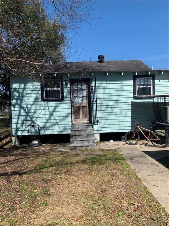 rear view of property with entry steps