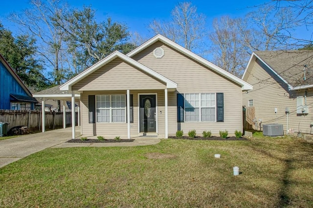2304 Pelican St, Slidell, LA 70460 - view of front facade featuring driveway, fence, a front lawn, and central AC unit
