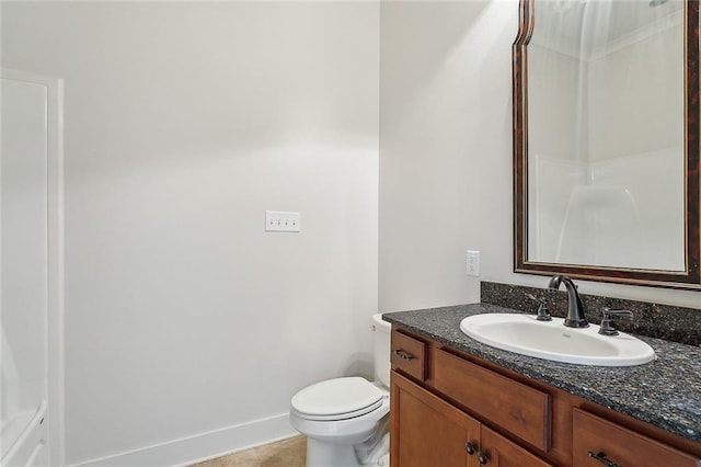 bathroom with toilet, tile patterned flooring, vanity, and baseboards