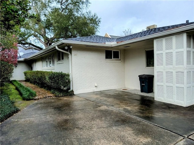 view of side of property featuring brick siding