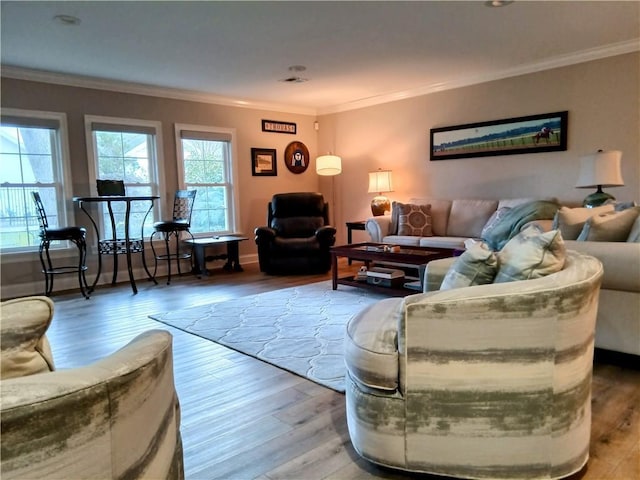 living area featuring visible vents, crown molding, and wood finished floors