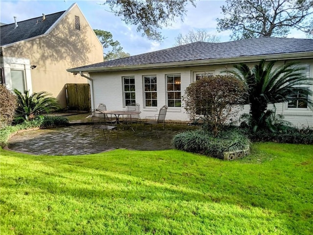 back of house featuring a yard and a patio area